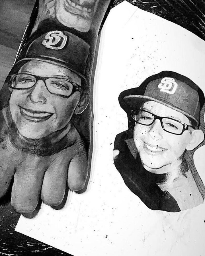High contrast black and grey memorial portrait tattoo of a father and son