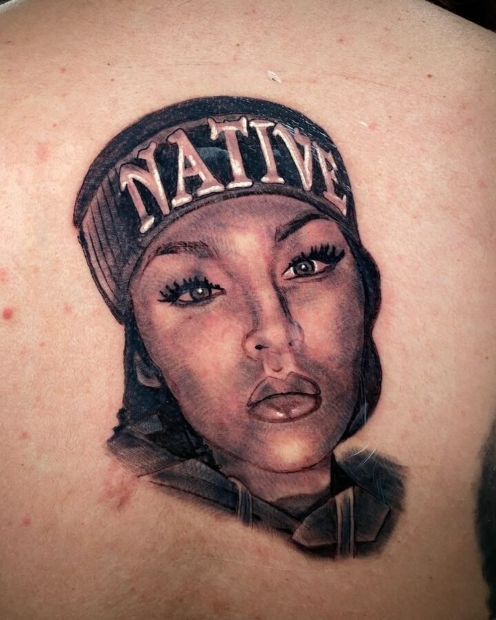 Black and grey portrait tattoo of a woman in a cap on the chest